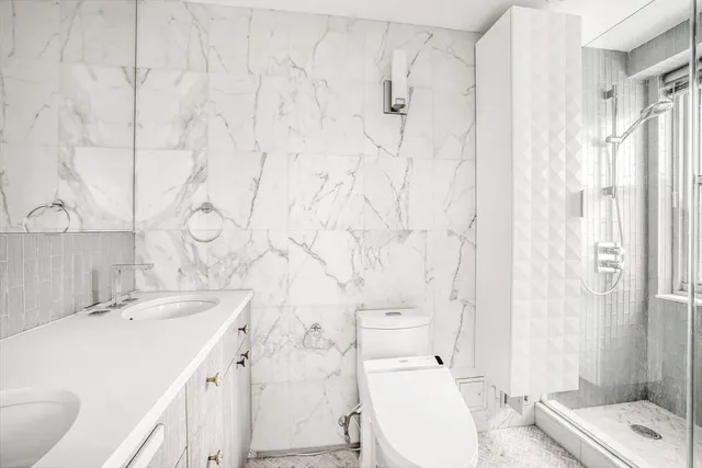 a bathroom with a sink toilet and shower