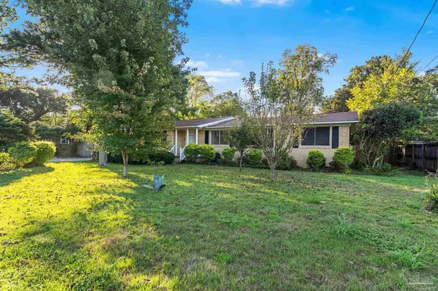 a view of a house with a backyard