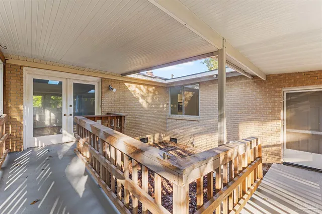 a roof deck with table and chairs