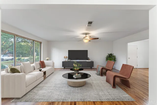 a living room with furniture and a large window
