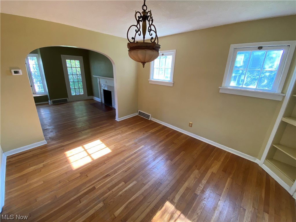 3630 Bainbridge Road Cleveland Heights, OH 44118 - Photo 7 of 21 Unfurnished living room with built in shelves and dark hardwood / wood-style floors