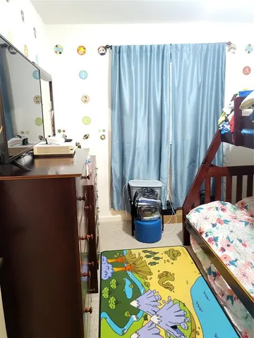 a bathroom with a sink a toilet and shower curtain