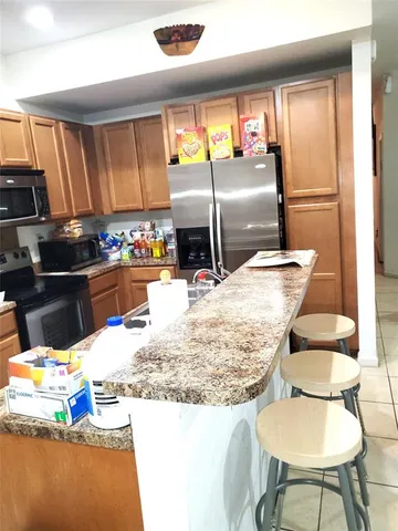 a kitchen with granite countertop a sink and a stove top oven