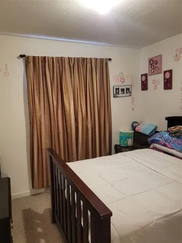a bedroom with a bed and a book shelf
