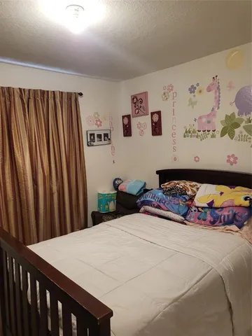 a bedroom with a bed and wall painting