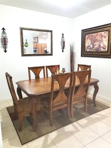 a view of a backyard with plants and wooden fence