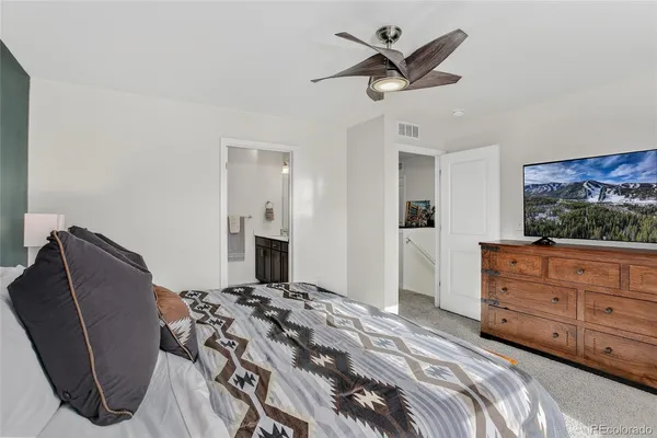 a bedroom with a bed dresser and a window