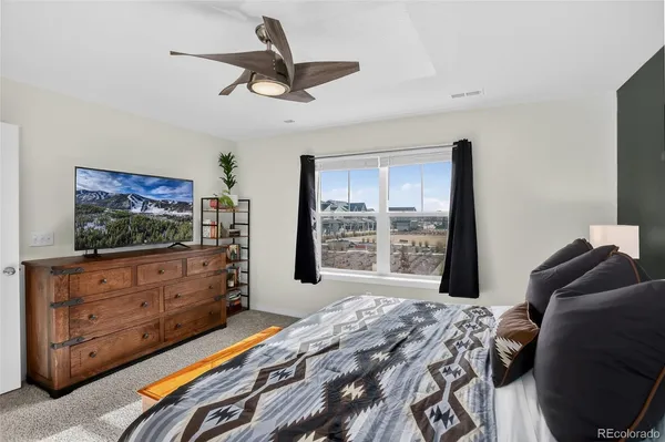 a bed room with a bed a television and a window