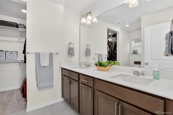 a bathroom with a sink double vanity and a mirror