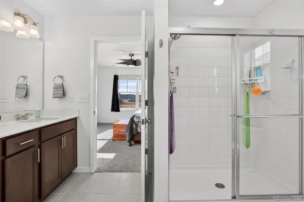 a bathroom with a double vanity sink a mirror and a shower