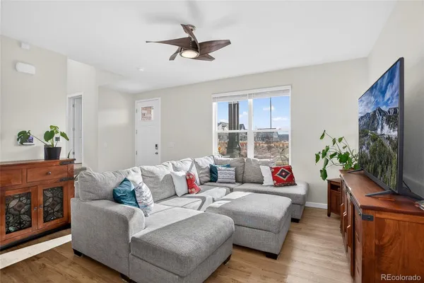 a living room with furniture a flat screen tv and a fireplace