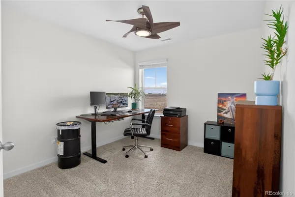 a view of a workspace with furniture