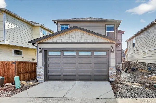 a front view of a house with garage