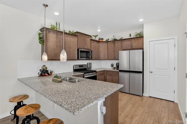 a kitchen with kitchen island a refrigerator stove and microwave
