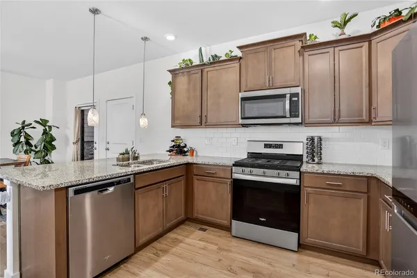 a kitchen with a sink stove and microwave
