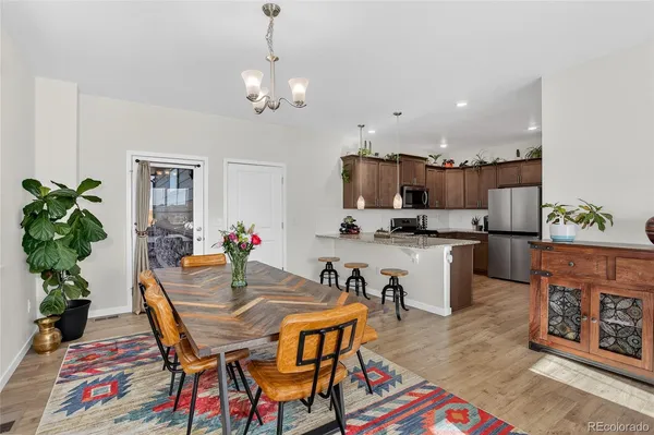 a view of a dining room with furniture and wooden floor