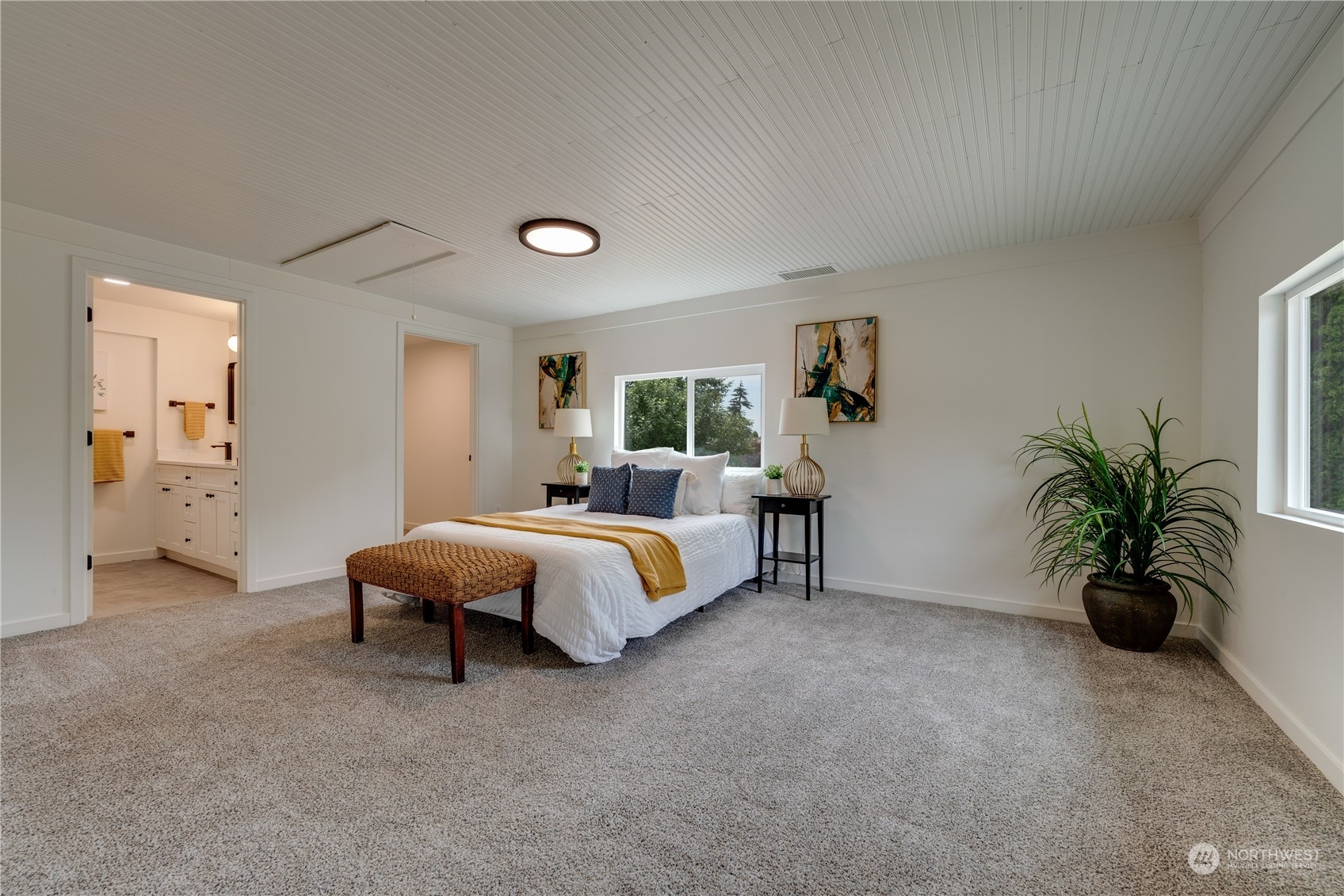 17822 85th Place Northeast Bothell, WA 98011 - Photo 22 of 33 a spacious bedroom with a bed and a potted plant