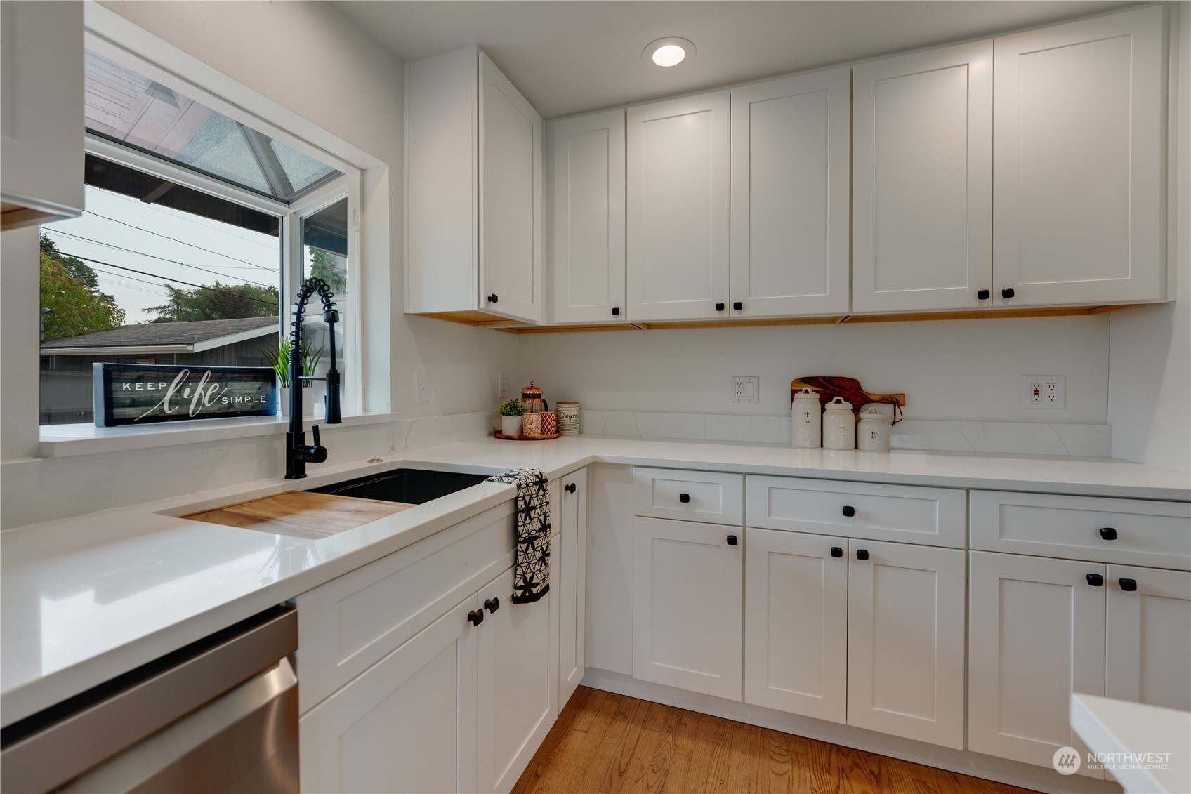 17822 85th Place Northeast Bothell, WA 98011 - Photo 10 of 33 a kitchen with granite countertop white cabinets and sink