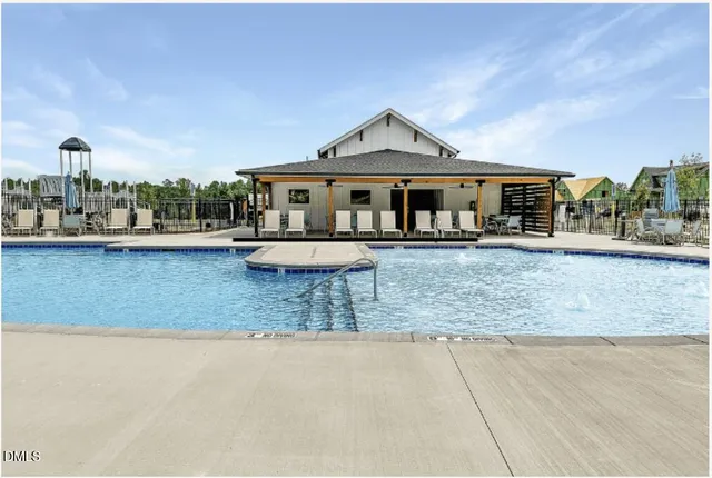 a front view of a house with a yard and potted plants