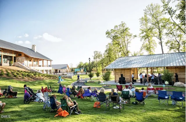 a group of people sitting in front of retail shop