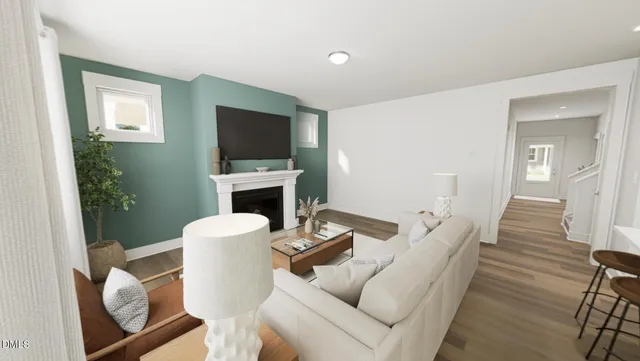 a living room with furniture a flat screen tv and a fireplace