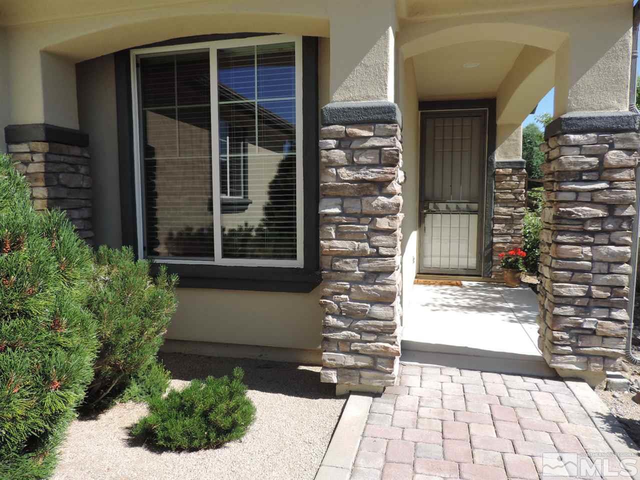 9101 Quilberry Way Reno, NV 89523 - Photo 3 of 20 a front view of a house with a yard