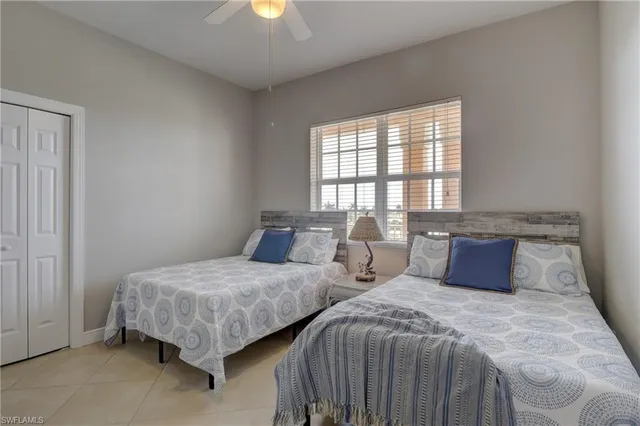 a bedroom with two beds and a window