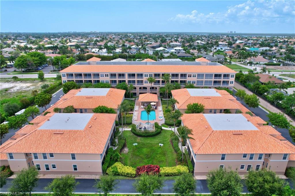 1857 San Marco Road, Unit PH3 Marco Island, FL 34145 - Photo 18 of 24 an aerial view of multiple houses with yard