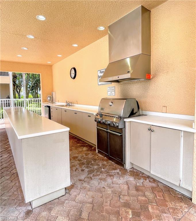 1857 San Marco Road, Unit PH3 Marco Island, FL 34145 - Photo 20 of 24 a kitchen with a stove a sink and a refrigerator