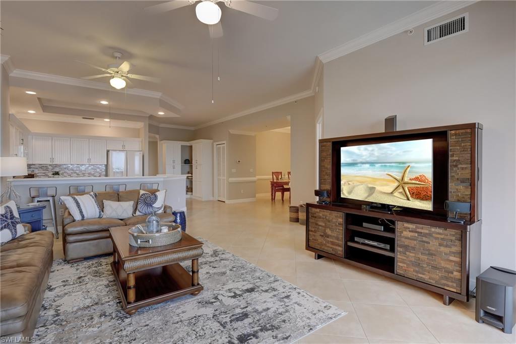 1857 San Marco Road, Unit PH3 Marco Island, FL 34145 - Photo 2 of 24 a living room with furniture and a flat screen tv