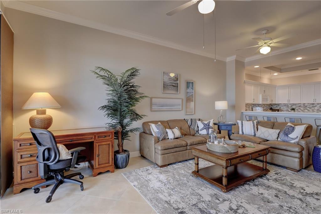 1857 San Marco Road, Unit PH3 Marco Island, FL 34145 - Photo 3 of 24 a living room with furniture a lamp and a fireplace
