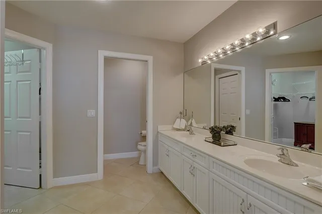 a bathroom with a double vanity sink and a mirror