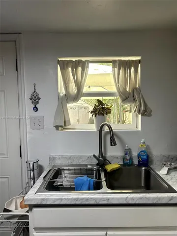 a kitchen with a sink and a window