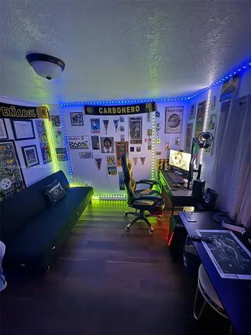 a living room with patio furniture and a rug