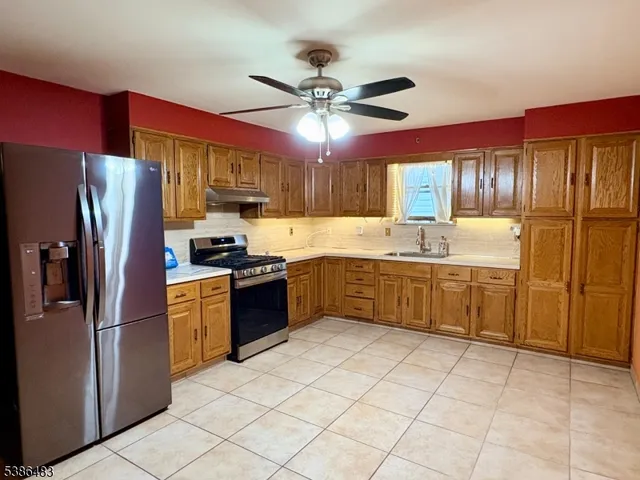 a kitchen with stainless steel appliances granite countertop a refrigerator sink and cabinets