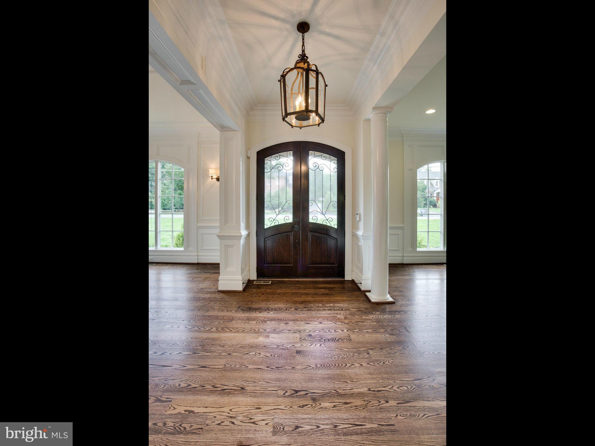 926 Douglass Drive McLean, VA 22101 - Photo 1 of 29 a view of a hallway with wooden floor and a chandelier