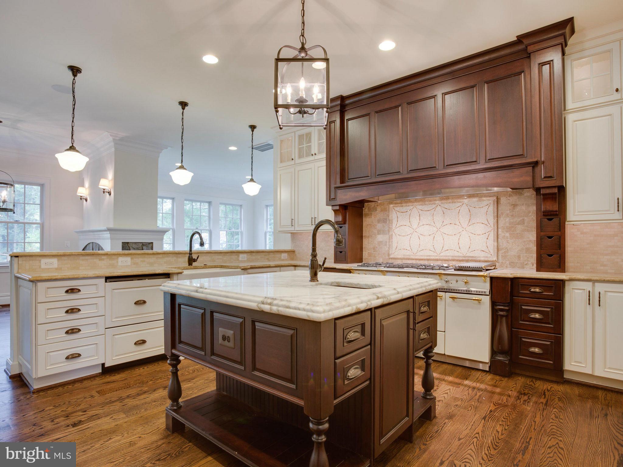 926 Douglass Drive McLean, VA 22101 - Photo 5 of 29 a kitchen with kitchen island granite countertop wooden cabinets and a stove