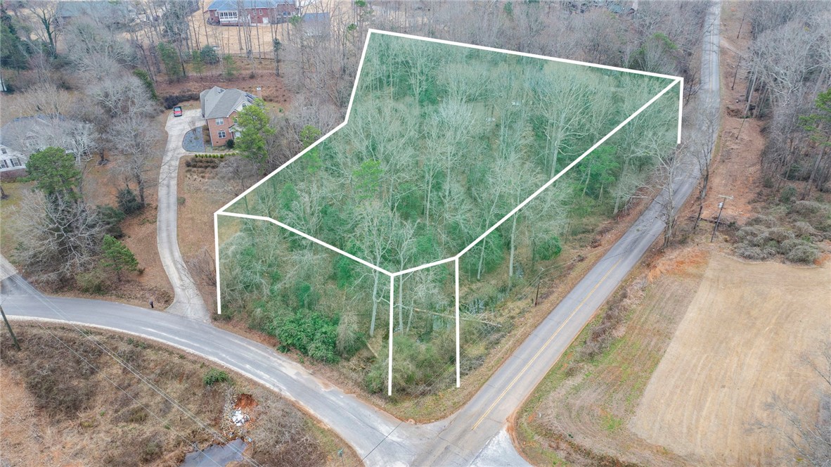 A spacious lot with ample greenery awaits your vision for a custom home.