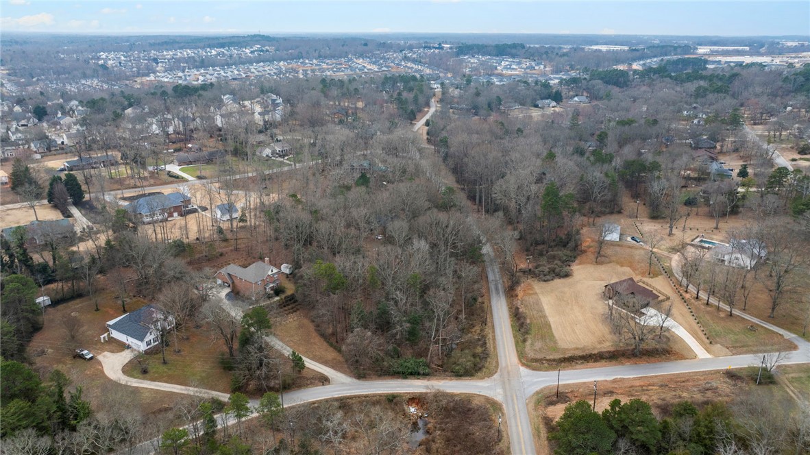 0 Standing Springs Road Greenville, SC 29605 - Photo 12 of 25 This expansive aerial view showcases a desirable community with abundant mature trees and well-maintained properties.