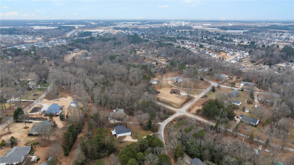 0 Standing Springs Road Greenville, SC 29605 - Photo 13 of 25 An aerial perspective reveals a sprawling residential area surrounded by a serene natural landscape.