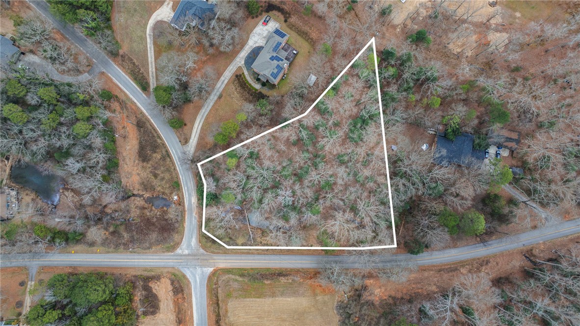 0 Standing Springs Road Greenville, SC 29605 - Photo 2 of 25 An aerial view showcases a verdant lot nestled among roads and neighboring properties, ideal for development.