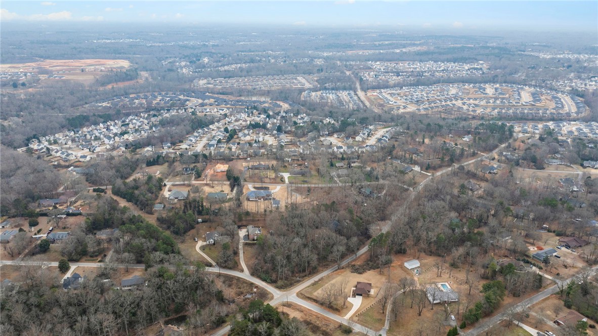 0 Standing Springs Road Greenville, SC 29605 - Photo 8 of 25 An aerial perspective reveals a sprawling residential landscape nestled within a wooded environment.