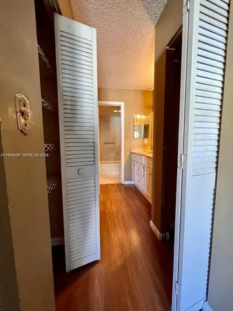 a view of hallway with wooden floor