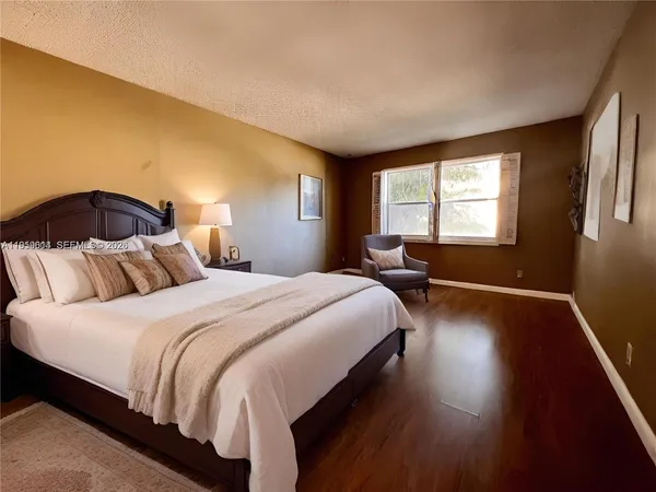 a bedroom with bed and window