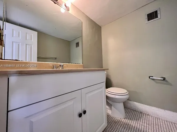a bathroom with a sink toilet and a mirror