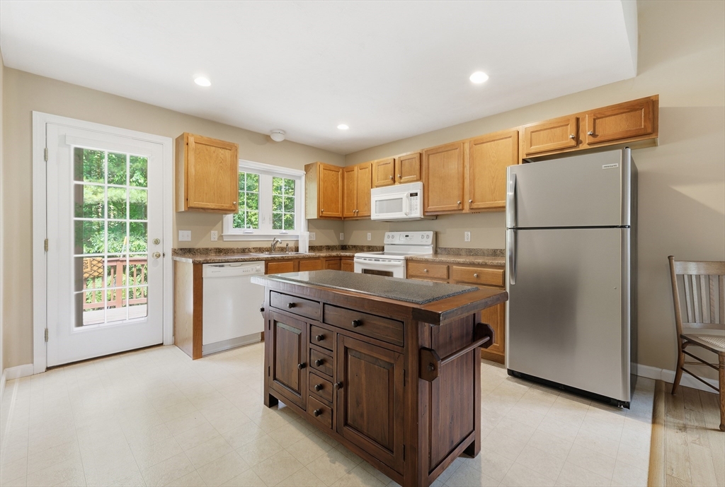 9 Rock Marsh Road, Unit B Wareham, MA 02571 - Photo 14 of 41 a kitchen with stainless steel appliances granite countertop a refrigerator a sink a stove and a refrigerator