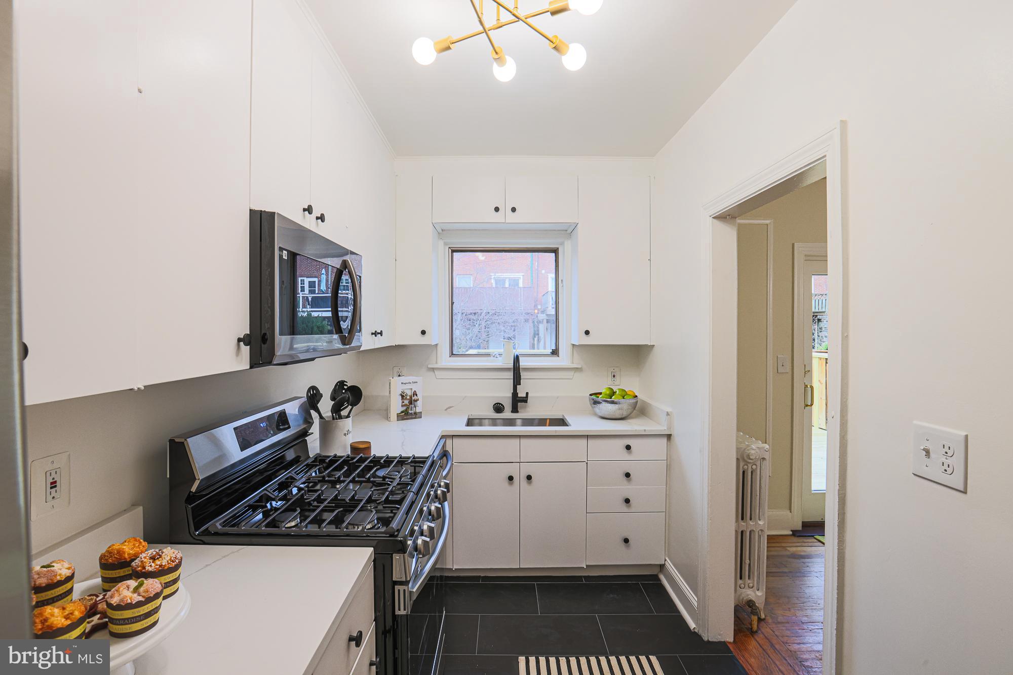 3716 Rexmere Road Baltimore, MD 21218 - Photo 22 of 54 a kitchen with a sink stove and cabinets
