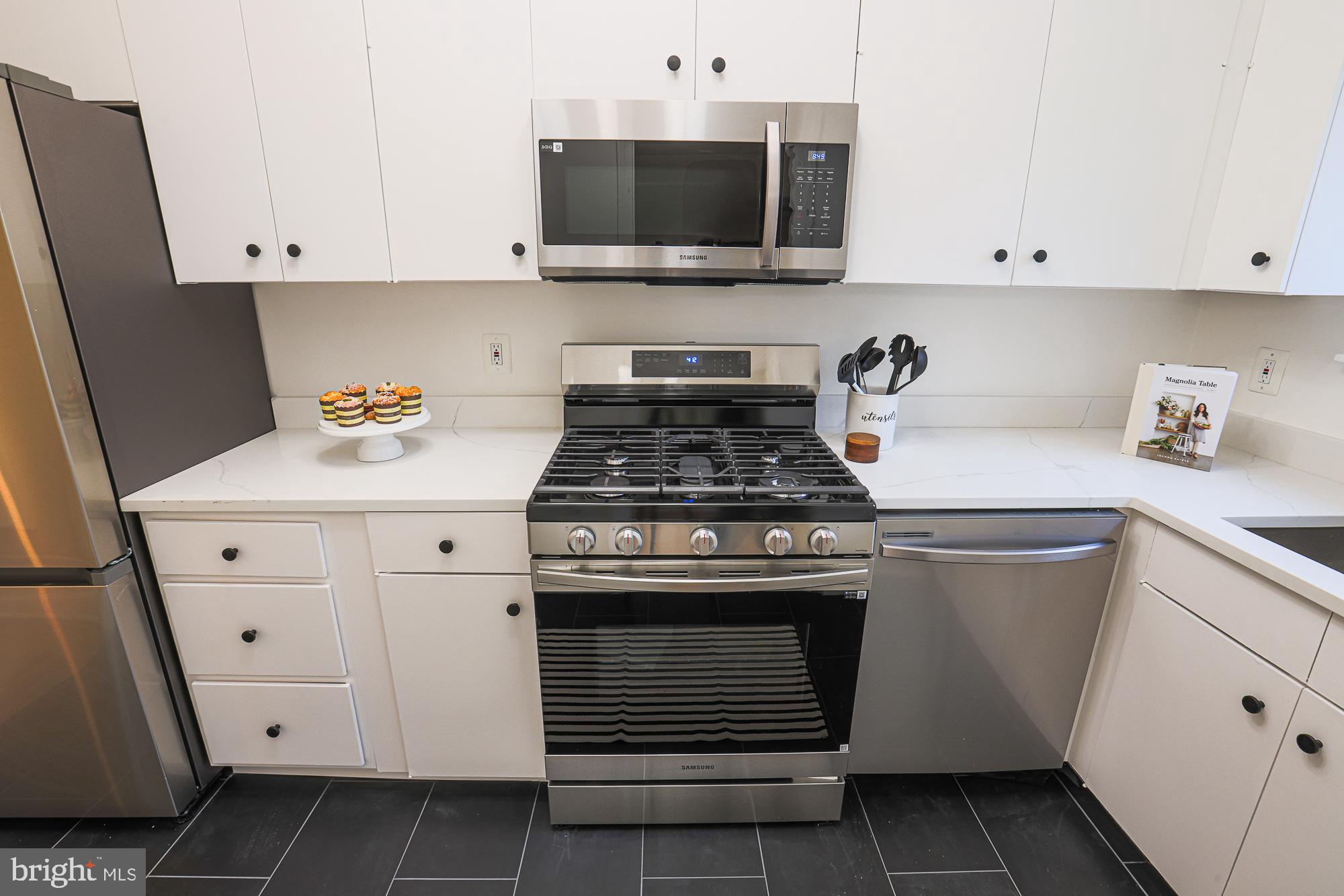 3716 Rexmere Road Baltimore, MD 21218 - Photo 24 of 54 a kitchen with granite countertop white cabinets and stainless steel appliances