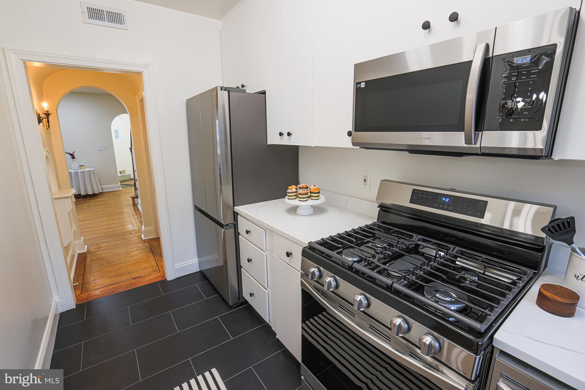 3716 Rexmere Road Baltimore, MD 21218 - Photo 25 of 54 a kitchen with a stove and a refrigerator