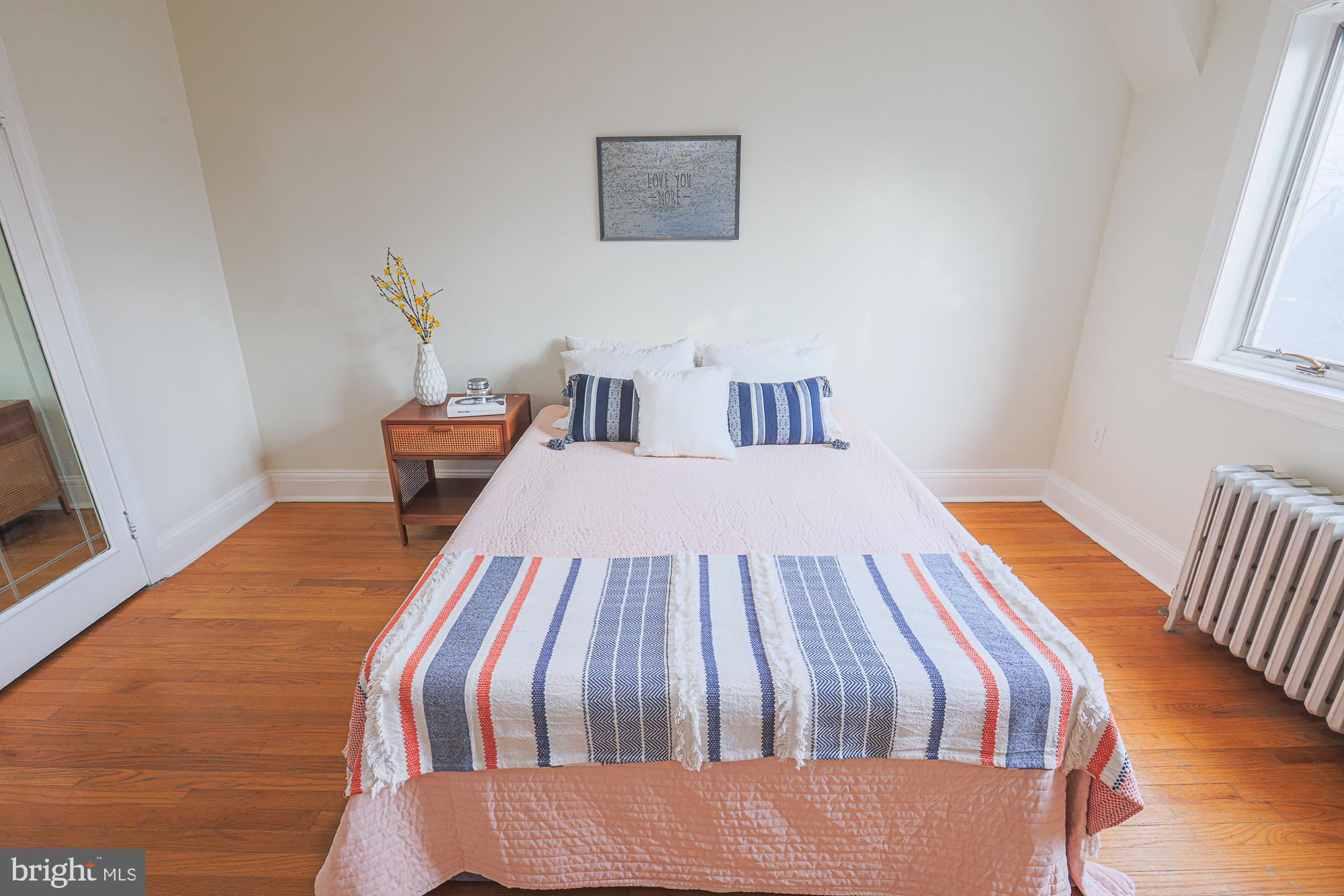3716 Rexmere Road Baltimore, MD 21218 - Photo 30 of 54 a bedroom with a bed and wooden floor